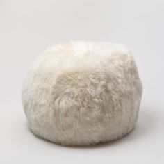 a white sheepskin beanie sitting on top of a table