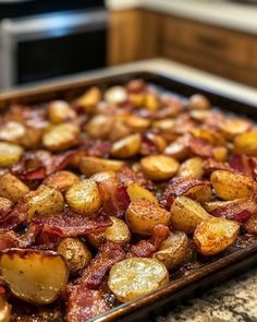 cooked potatoes and bacon on a baking sheet in the kitchen, ready to be eaten