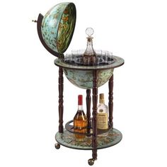 a wine glass holder on wheels with bottles in the bottom and an earth globe above it