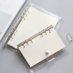 a clear binder with two rings on it