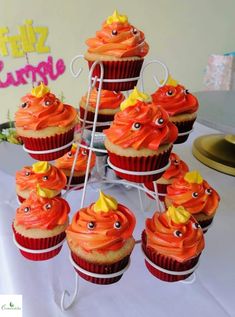 cupcakes with orange frosting and yellow decorations