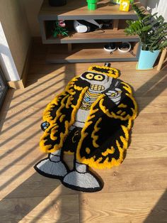 a rug that looks like a cartoon character is on the floor next to a shelf