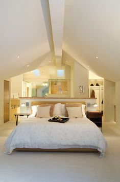 a large bed sitting in the middle of a bedroom