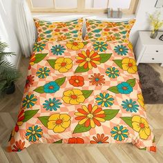 a bed with an orange and yellow flower pattern on it