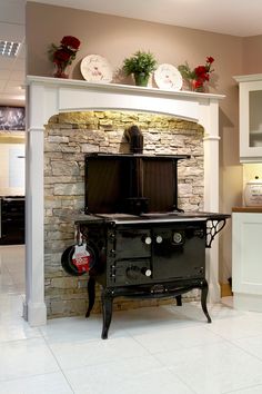 an old fashioned stove sits in the middle of a kitchen