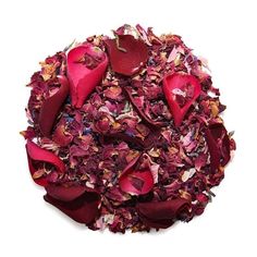 a pile of dried rose petals sitting on top of a white table