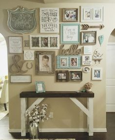 a wall with many pictures and frames on it