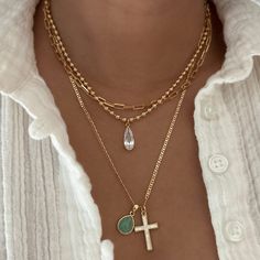 This beautiful necklace features a 24k gold-filled cross pendant with a shell opal inlay, paired with a Aventurine gemstone teardrop charm. The combination of the classic cross and the vibrant Aventurine teardrop adds a unique, elegant touch, perfect for layering or wearing solo. 14k Gold Filled Chain 24k Gold Filled Cross Pendant: 22.4mm x 14.4mm 24k Gold Filled Teardrop Charm: 14.2mm x 9.7mm Chain length: 20" Lobster clasp closure Hypoallergenic Water resistant & tarnish free Nickel & lead fre Desi Necklace, Layering Jewelry, Layered Jewelry, Gold Necklace Layered, Teardrop Necklace, Beautiful Necklace, Gold Filled Chain, Chain Lengths, Chain Length