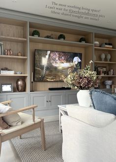 a living room filled with furniture and a flat screen tv mounted on the wall above it