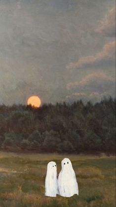 two white ghost figures standing in a field with the sun setting over trees behind them