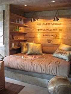 a bed sitting inside of a bedroom next to a wooden wall