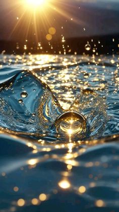 water splashing on the surface with sun shining in the background and blue sky above