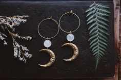 "Boho beauties made from floral brass moons adorned with aura quartz gemstone beads and hung on gold plated brass hoops. They measure approximately 3\" long." Bohemian Hoop Earrings With Moon Charm Dangle, Bohemian Dangle Hoop Earrings With Moon Charm, Bohemian Crescent Hoop Earrings With Moon Charm, Bohemian Hoop Earrings With Moon Charm, Bohemian 14k Gold Filled Hoop Earrings, Handmade Moon Shaped Bohemian Hoop Earrings, Bohemian Gold Hoop Earrings With Moon Charm, Moon Aura, Metalsmithing Jewelry