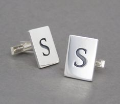 Sleek, modern cufflinks made of sterling silver with a custom monogram of the same letter on each cufflink. Elegant heirloom quality cufflinks for all dress occasions. This listing is for a pair of cufflinks with the same letter.Size is 3/4" X 9/16".  Please see my other listing for cufflinks with two different letters. Perfect for groomsmens' gifts - Wedding parties discount!  Order more four or more pairs and get one pair at half price! Send me a convo and I will create a custom listing for yo Silver Initials Cufflinks For Business, Classic Silver Cufflinks With Initials, Silver Initials Cufflinks For Formal Wear, Classic Cufflinks With Initials For Wedding Gift, Monogrammed Cufflinks, Mens Monogram, Wedding Parties, Labradorite Ring, Sterling Silver Mens