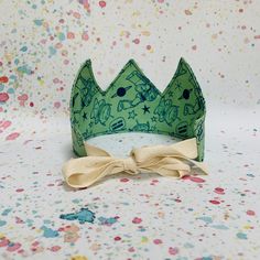 a green crown with a bow on it