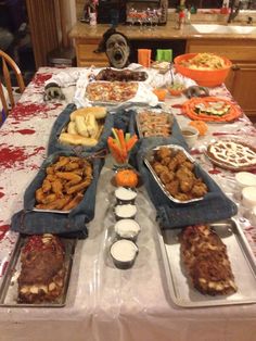 a table full of food that includes meats and vegetables