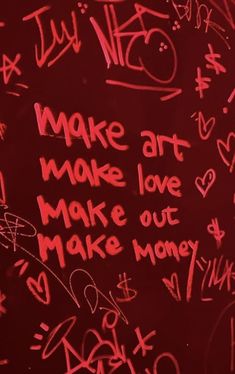 graffiti written on the side of a wall with writing in red and white ink that says make art, make love, make money