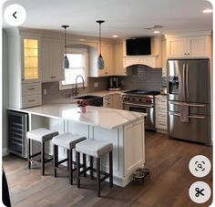 a kitchen with an island and three stools in front of the stove top oven