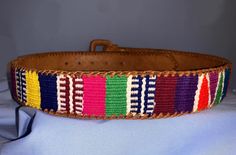 ~ This artisanal adult's leather belt is ideal for adding a splash of color to your outfits yet keeping it stylish! ~ Adult leather belt with handwoven fabric made by Guatemalan artists! ~ All of the profits from this sale go to organizations like Cojolya Association that give back to the Maya women by providing them medical care! Adjustable Artisan Multicolor Belt, Adjustable Handmade Multicolor Belt, Artisan Multicolor Fabric Belt, Casual Multicolor Fabric Belt, Multicolor Embroidered Leather Belt, Adjustable Multicolor Leather Belts, Embroidered Leather, Handwoven Fabric, Give Back