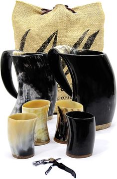 black and white vases are sitting next to a burluck bag on the floor