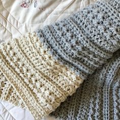 three crocheted blankets laying on top of each other