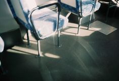 two blue chairs sitting next to each other in a room