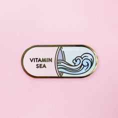 a sticker with the words vitamin sea on it in front of a pink background