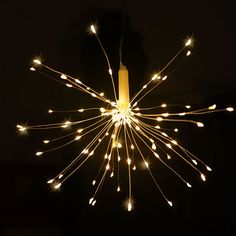 a lighted star shaped object in the dark with white lights on it's sides