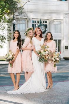 three bridesmaids in pink dresses posing for the camera