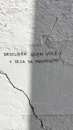 a cement wall with writing on it and the words descubra quem voce e