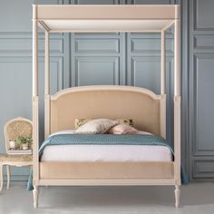 a bedroom with a canopy bed and blue walls