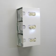 two white boxes are stacked on top of each other with money sticking out of them