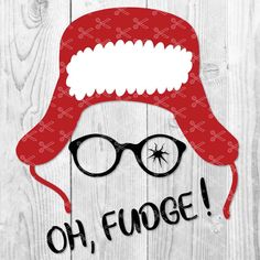 a red hat and glasses with the words oh fudge on it, against a white wooden background