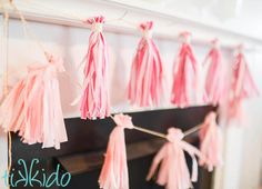 pink tassels hanging from a fireplace mantel