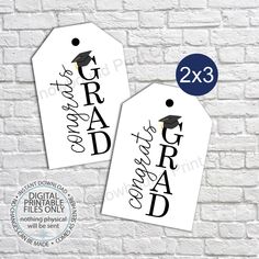 two graduation gift tags with the words graduate and mortar on them, against a white brick wall