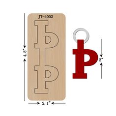 a wooden sign with the letter p on it next to a metal keychain