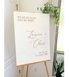 an easel with a sign that says we're so glad you're here