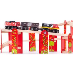 a wooden toy train set with cars and tracks on top of each other in front of a white background