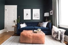 a living room filled with furniture and pictures on the wall above it's coffee table