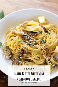 a white plate topped with pasta and mushrooms