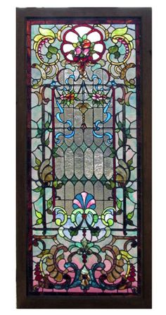 a stained glass window with an ornate design on the front and side panel, in brown frame