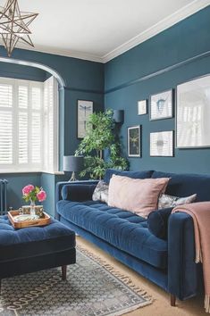 a living room with blue walls and furniture