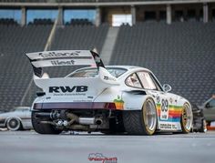 a white race car parked on top of a parking lot