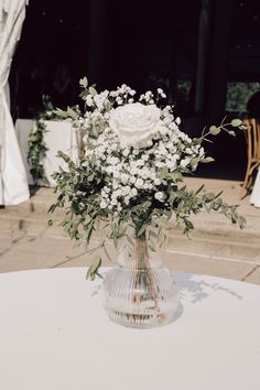 White roses and baby's breath work perfectly against greenery to create a simple yet elegant centerpiece during cocktail hour.

-Frame 805 Photography Baby's Breath Centerpiece, Engagement Party Centerpieces, Simple Floral Centerpieces, Greenery Wedding Centerpieces, White Floral Centerpieces, Breath Work