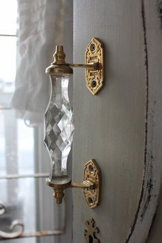 an old fashioned door handle with glass knobs