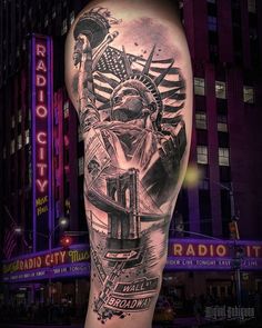 the statue of liberty is on top of an american flag in this black and grey tattoo