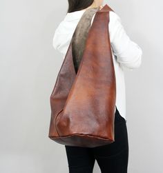 "Brown leather boho bag, Crossbody hobo bag with comfortable strap, Boho slouch bag, Oversized brown hippie bag -Brown leather hippie bag . -Cognac brown cowchide leather. - Inner pocket with zipper - Magnet closure bag DIMENSIONS: - height of bag with strap: 31,5\" ( 80 cm) - height without strap: 11.8\" ( 30 cm) - width at the entrance: 21.3\" ( 54 cm) - rectangle shaped bottom: 11.5\" x 9,5 ( 24 cmx29cm) MORE COLORS: MUSTARD: https://www.etsy.com/listing/825959932/mustard-leather-womens-hippi Bohemian Brown Hobo Bag For Everyday, Handmade Brown Hobo Bag, Handmade Everyday Hobo Bag, Bohemian Soft Leather Hobo Bag For Everyday, Everyday Bohemian Soft Leather Hobo Bag, Brown Hobo Bag With Removable Pouch, Everyday Handmade Brown Hobo Bag, Everyday Brown Handmade Hobo Bag, Brown Soft Leather Hobo Bucket Bag