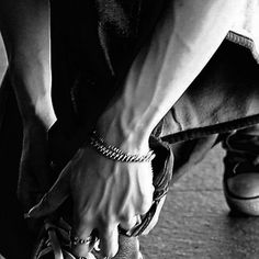 black and white photograph of someone tying their shoes