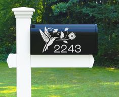 a mailbox with the number 22 on it in front of some trees and grass