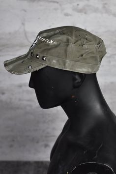 Introducing the Melting Skull Field Cap - the epitome of apocalyptic style and edgy streetwear. This dystopian cap is not your average everyday headwear; it's a statement piece that will set you apart in any post-apocalyptic landscape. Made from top-noch cotton. Crafted with meticulous attention to detail, this field cap features subtle distressing, rugged frayed edges, visible stitching, and square studs, adding to its gritty and unique charm. The apocalyptic clothing aesthetic is perfectly captured in this project. The centerpiece of this cap is the mesmerizing melting skull patch, a hauntingly beautiful symbol of the post-apocalyptic world. It serves as a reminder of the edginess and individuality that come with embracing the apocalyptic style. Whether you're looking for sun protection Military Style Flat Cap For Streetwear, Alternative Adjustable Hat For Festivals, Alternative Style Adjustable Cap, Adjustable Alternative Style Cap, Punk Style Cap For Festivals, Military Style Visor Hat For Streetwear, Punk Style Festival Cap, Military Visor Hat For Streetwear, Apocalyptic Landscape